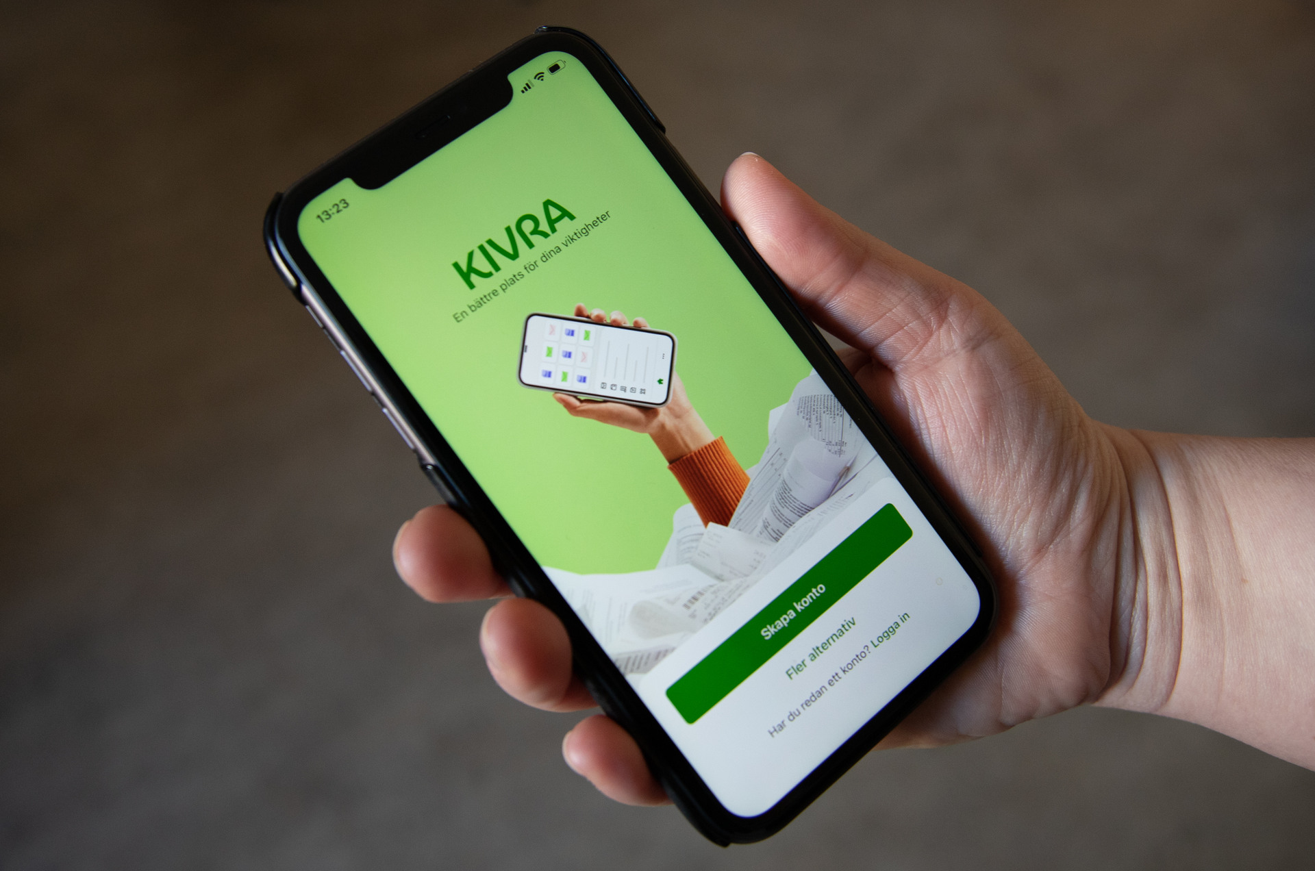 En person som håller en mobiltelefon i handen.