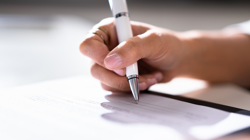 Lawyer Signing Business Contract Paper Document With Pen